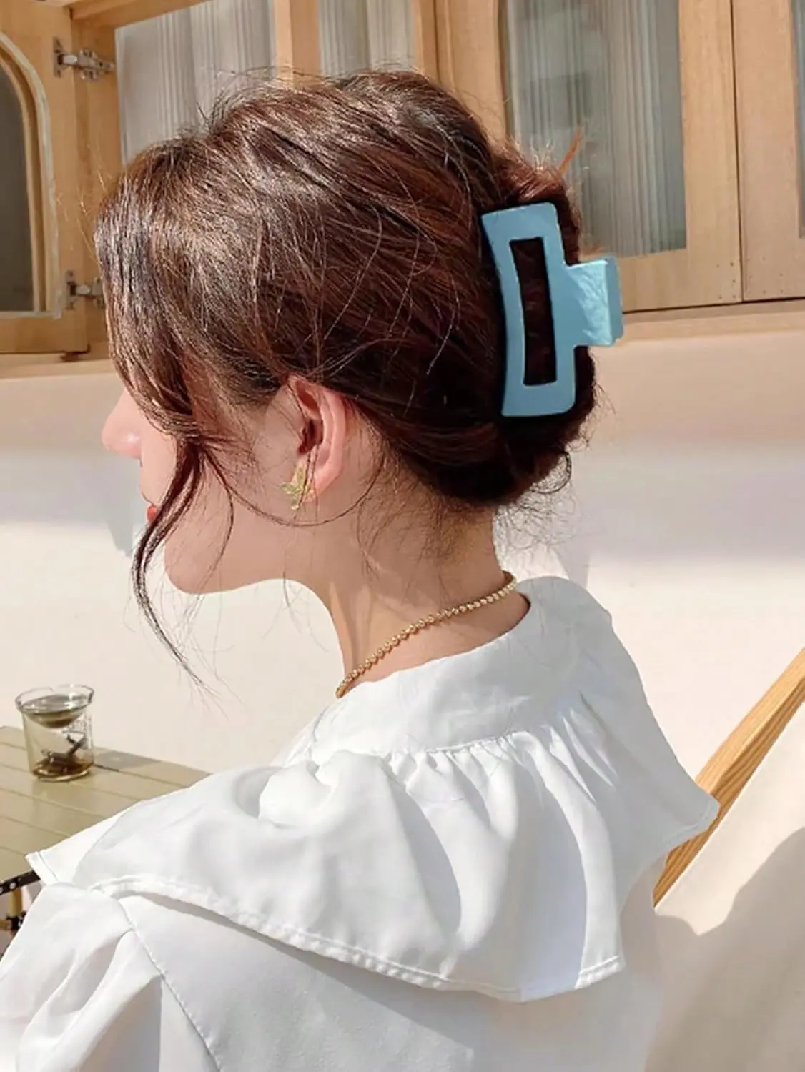 Three square hair claw clips in different colors securely holding thick hair for women.