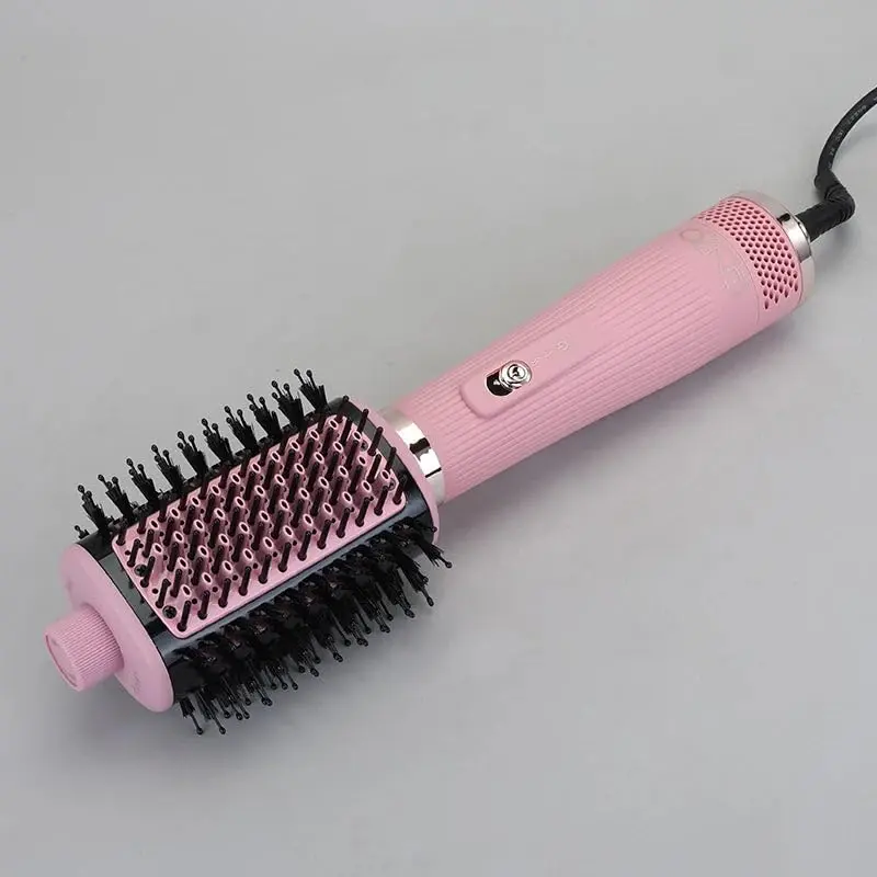 Pink 4-in-1 hair dryer brush with ionic technology for drying, straightening, volumizing and styling hair, featuring a lightweight and ergonomic design.