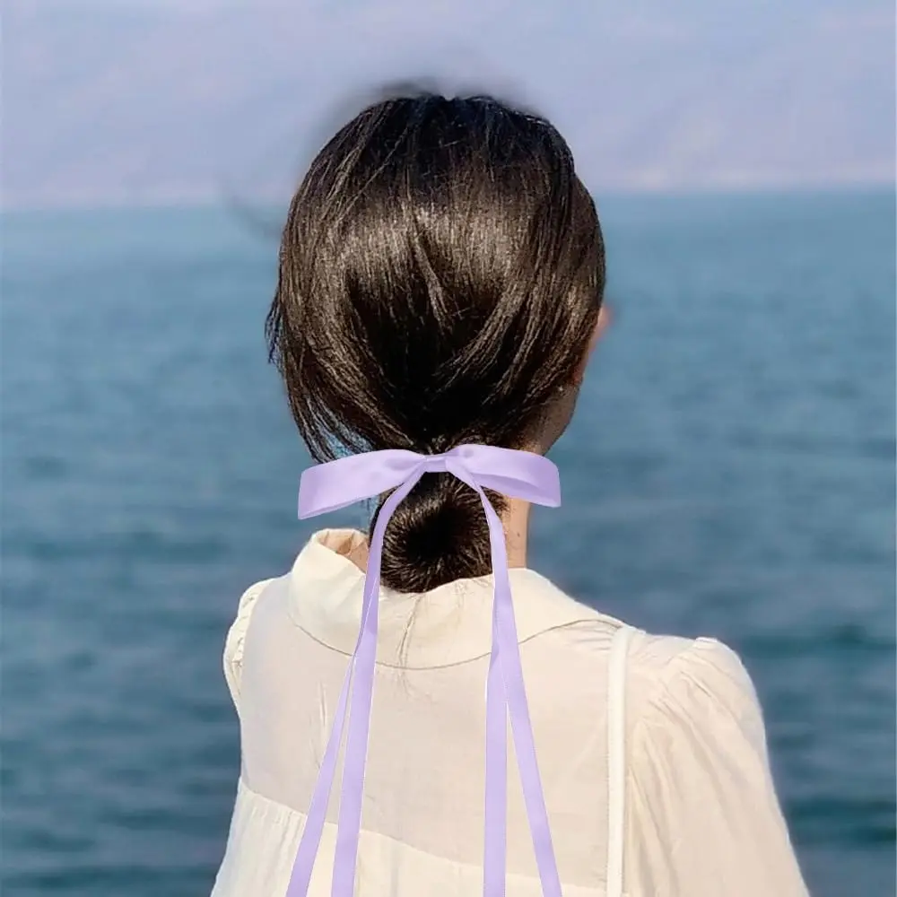 Two purple hair ribbon bows are displayed, perfect hair accessories for women and girls to add a sweet and lovely feeling to hairstyles for daily dressing, weddings, and special occasions.