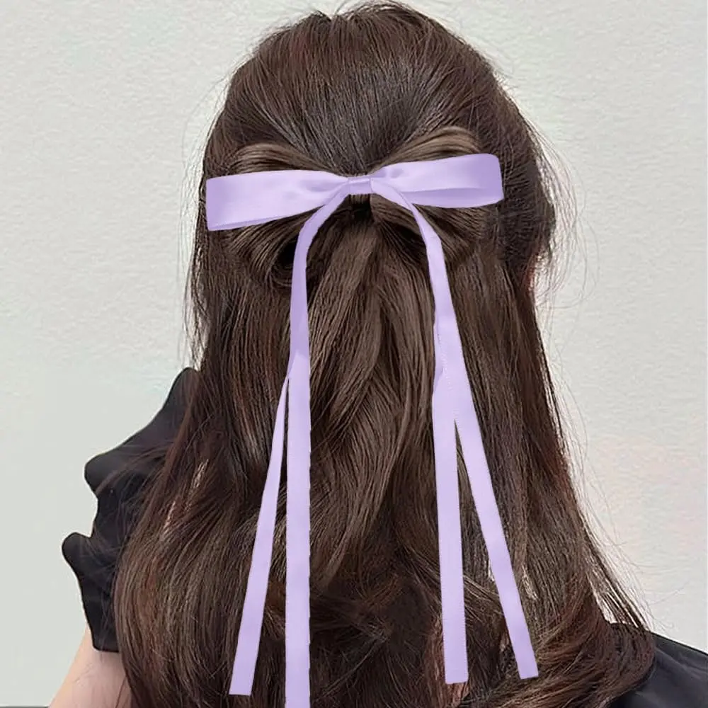 Two purple hair ribbon bows are displayed, perfect hair accessories for women and girls to add a sweet and lovely feeling to hairstyles for daily dressing, weddings, and special occasions.