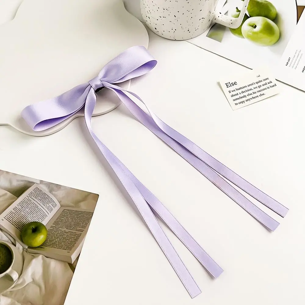Two purple hair ribbon bows are displayed, perfect hair accessories for women and girls to add a sweet and lovely feeling to hairstyles for daily dressing, weddings, and special occasions.