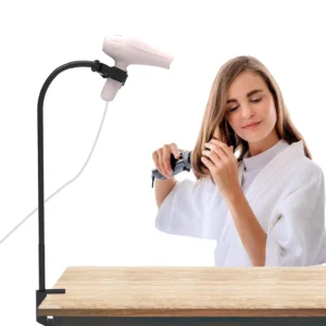 This hands free blow dryer holder is made of stainless steel and plastic, features an adjustable clamp, and is perfect for pet grooming tables and countertops.