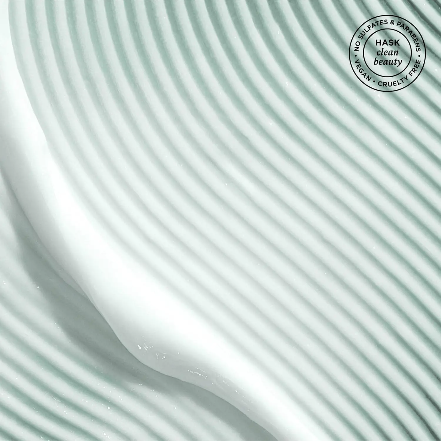 A single-use packet of Hask Tea Tree hair and scalp treatment mask, formulated without sulphates, parabens, or phthalates, and safe for color-treated hair.