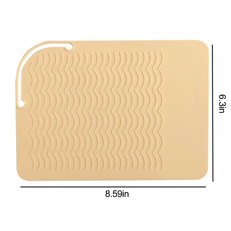 This pink silicone heat mat protects surfaces from damage caused by hot hair styling tools like curling irons and flat irons, making it perfect for travel or salon use.