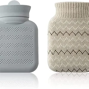This small grey hot water bottle with a soft knit cover provides comforting warmth for cold feet, cramps, or period pain, and is microwave-safe for easy heating.