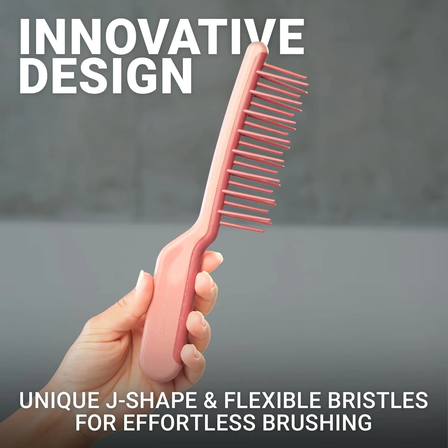 Pink Janeke J-Brush detangling comb with a curved J-shape handle and wide bristles designed to gently glide through curly hair, reducing frizz and breakage on wet or dry hair.