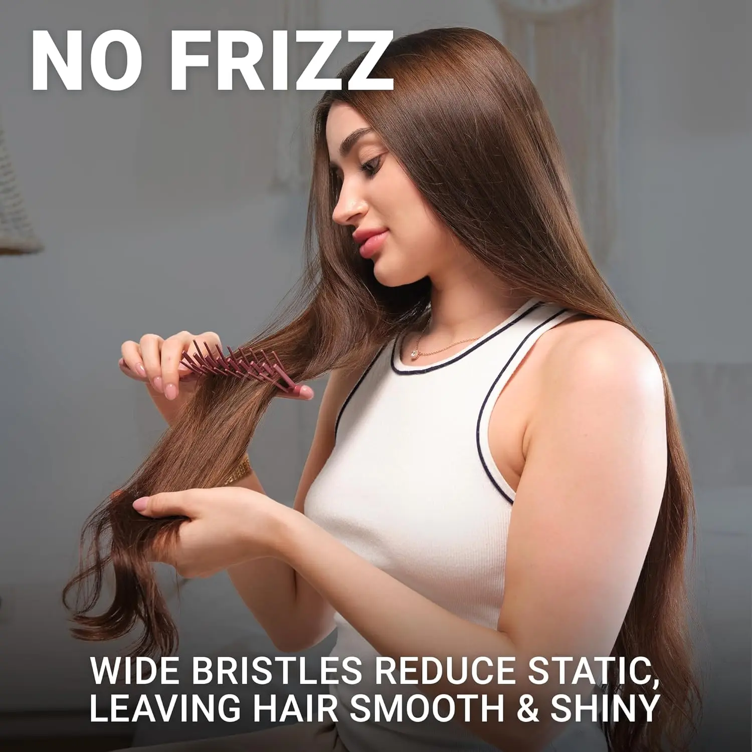 Pink Janeke J-Brush detangling comb with a curved J-shape handle and wide bristles designed to gently glide through curly hair, reducing frizz and breakage on wet or dry hair.