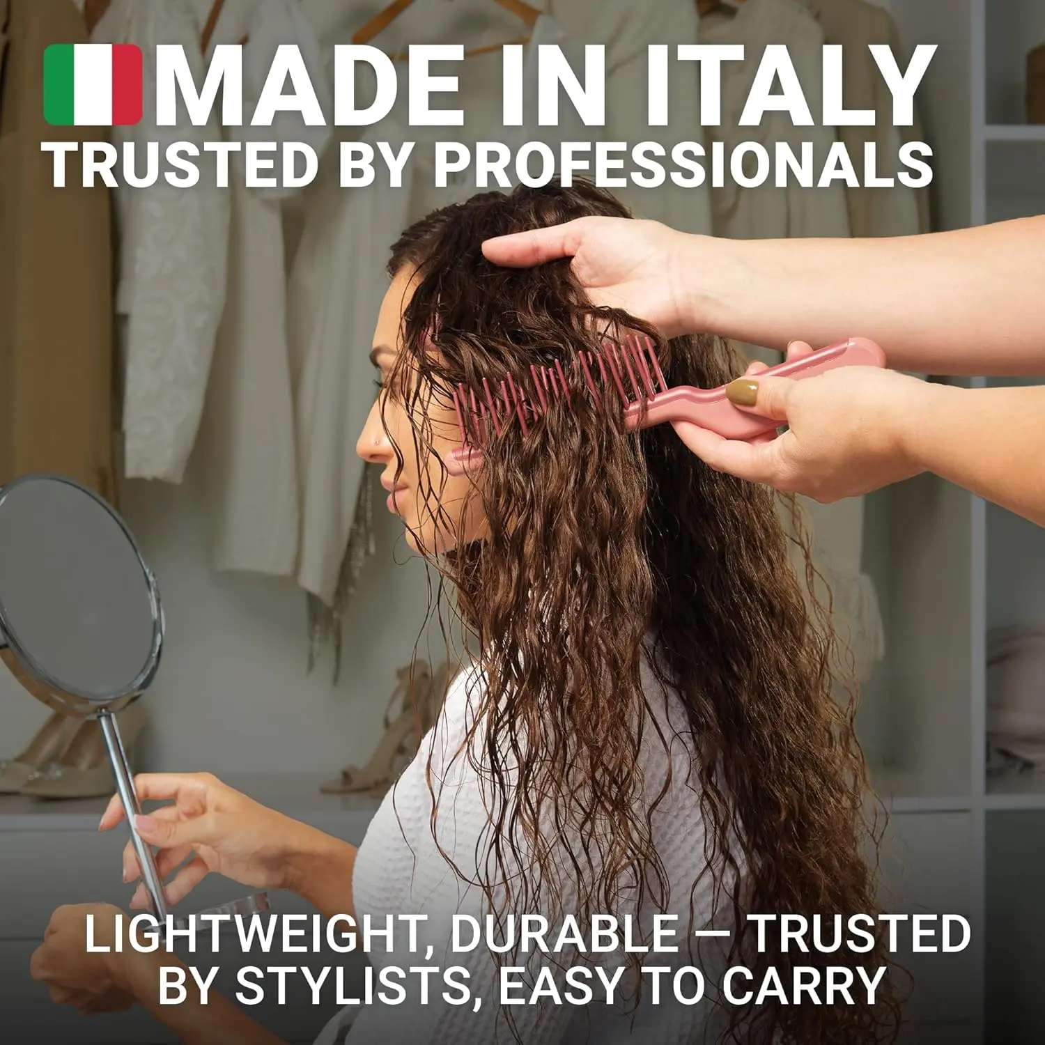 Pink Janeke J-Brush detangling comb with a curved J-shape handle and wide bristles designed to gently glide through curly hair, reducing frizz and breakage on wet or dry hair.