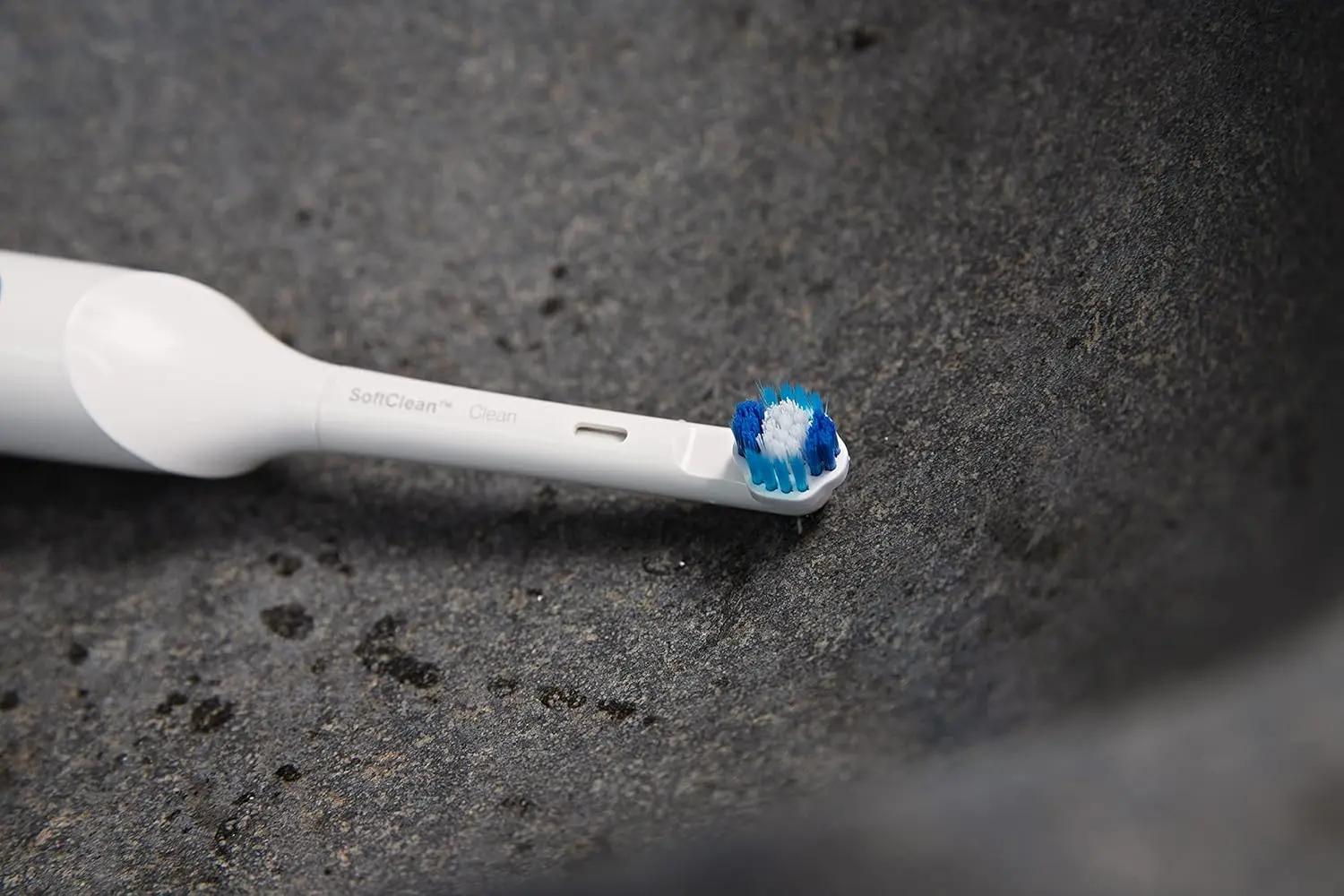 A small, white Jordan Clean Smile whitening brush head effectively removes plaque and stains, offering thorough and gentle cleaning for compatible electric toothbrushes.