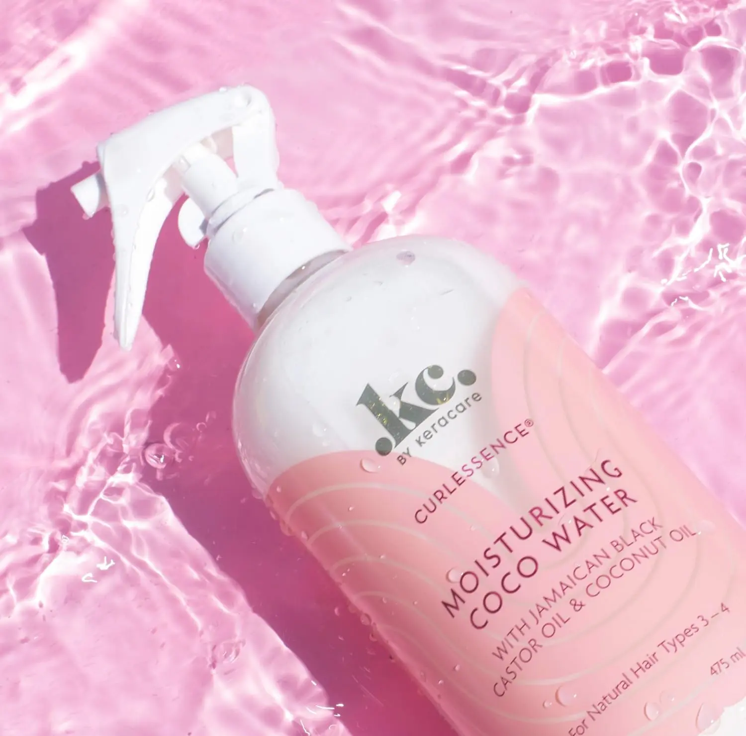 KeraCare COCO Water in a clear bottle with a white sprayer, designed to re-wet, moisturize, define curls, prevent frizz and add shine to hair.