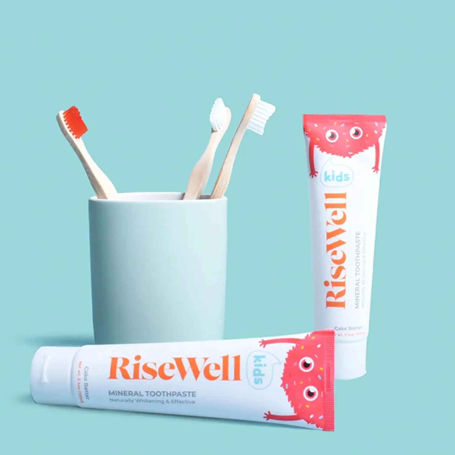 A tube of Risewell kids toothpaste with a cake batter scent is formulated with natural hydroxyapatite for gentle cleaning of children's sensitive teeth.