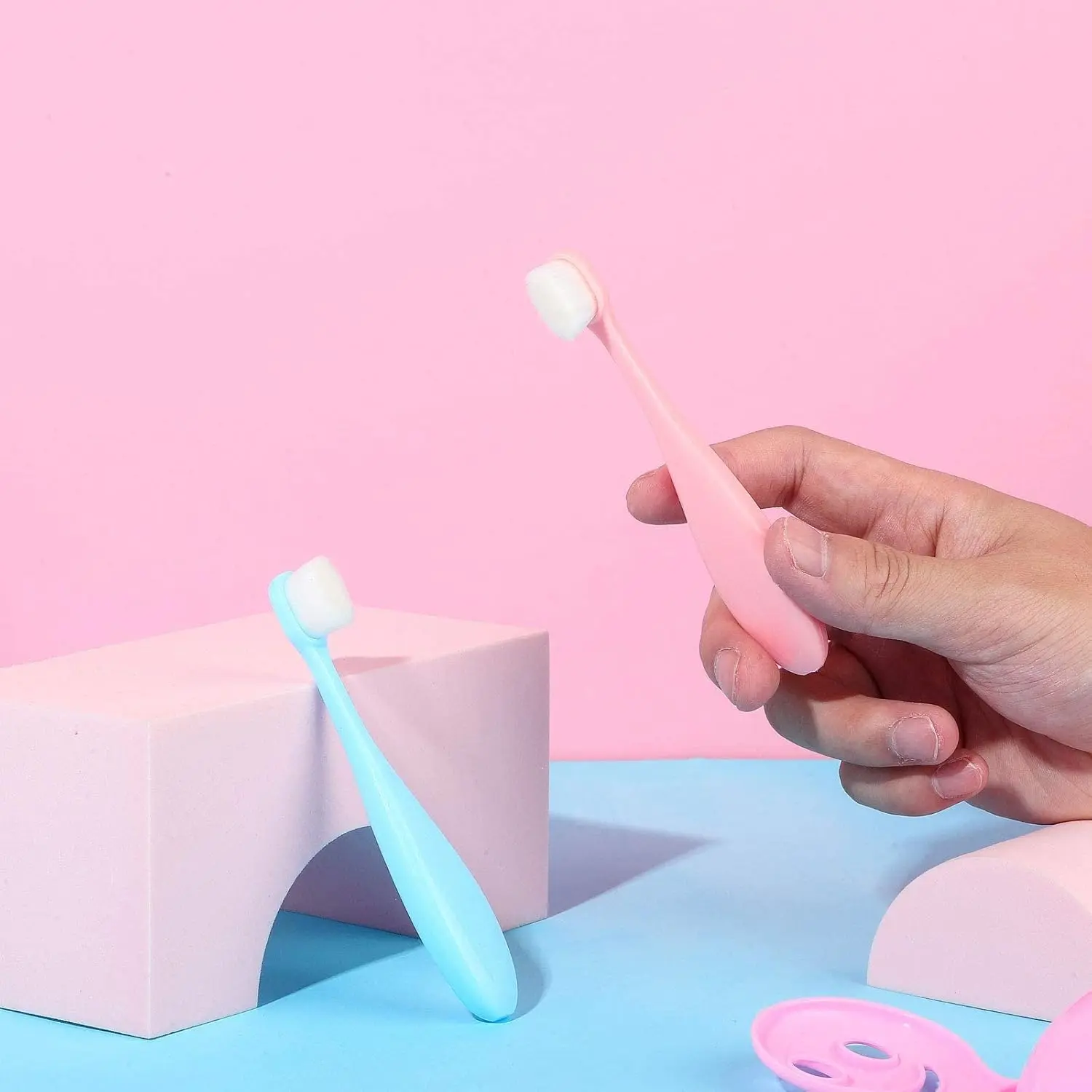 Four extra soft nano toothbrushes in blue and pink colors designed for toddlers and children for gentle and effective teeth cleaning.