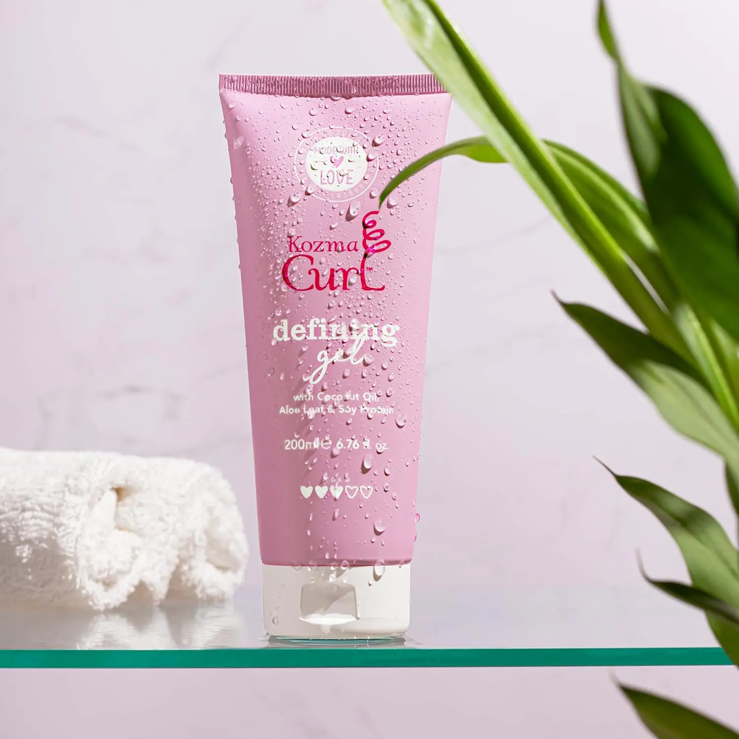 Kozma curl gel defines and styles all curl types while providing frizz and humidity protection with nourishing natural ingredients like aloe, soy protein, and coconut oil, and contains no silicones, parabens, or sulfates.