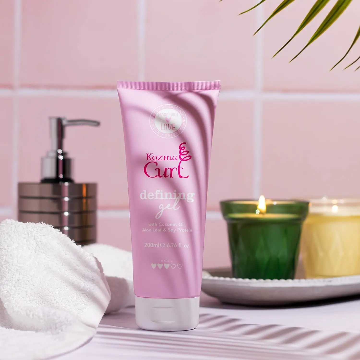 Kozma curl gel defines and styles all curl types while providing frizz and humidity protection with nourishing natural ingredients like aloe, soy protein, and coconut oil, and contains no silicones, parabens, or sulfates.