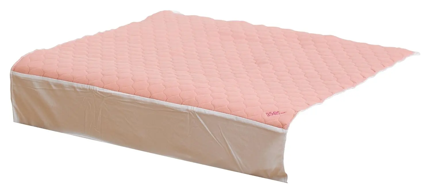 Pink Kylie bed pad with wings and tuck-in flaps providing waterproof and absorbent protection for day or night use.