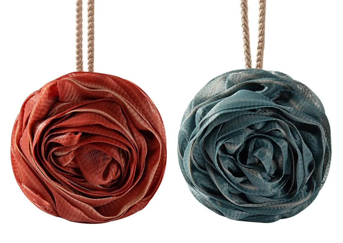 A four-pack of large, rose-shaped bath sponges designed to exfoliate and cleanse skin, creating a rich lather with shower gel or soap.