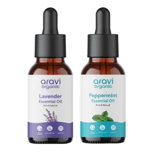 Amber glass bottles of pure lavender and peppermint essential oils for aromatherapy, skin, and hair care, promoting relaxation and a restful sleep.