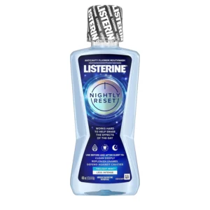 Bottle of Listerine Nightly Reset alcohol-free mouthwash in Twilight Mint flavor, designed to fight cavities, restore enamel, and freshen breath overnight.