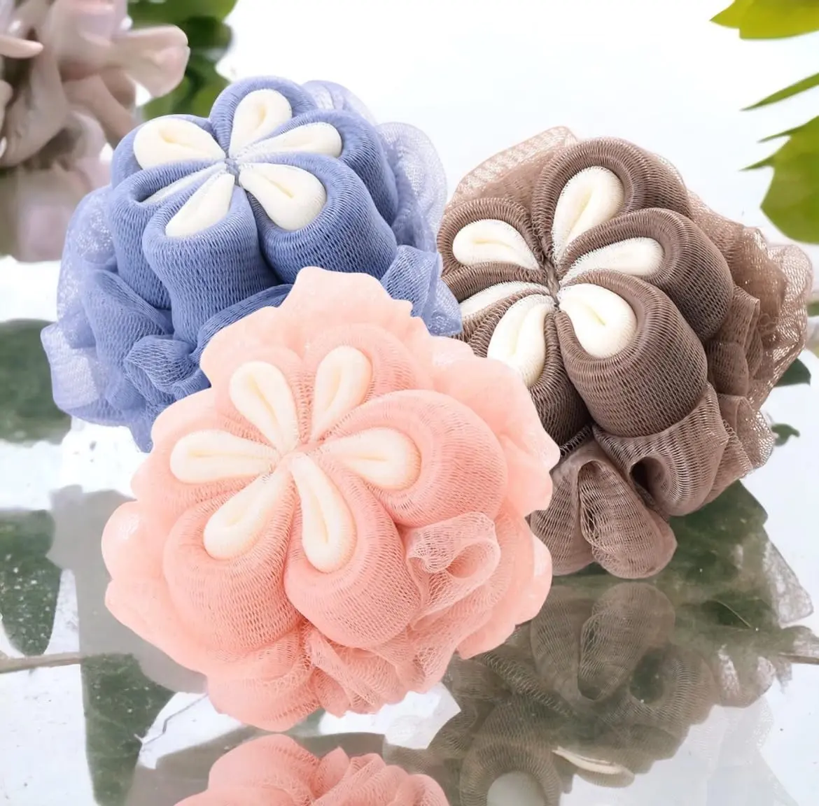 This is a 3 pack of MOMENT loofah bath sponges designed for exfoliating and cleansing the body, featuring soft mesh and long handles for easy use in the shower.