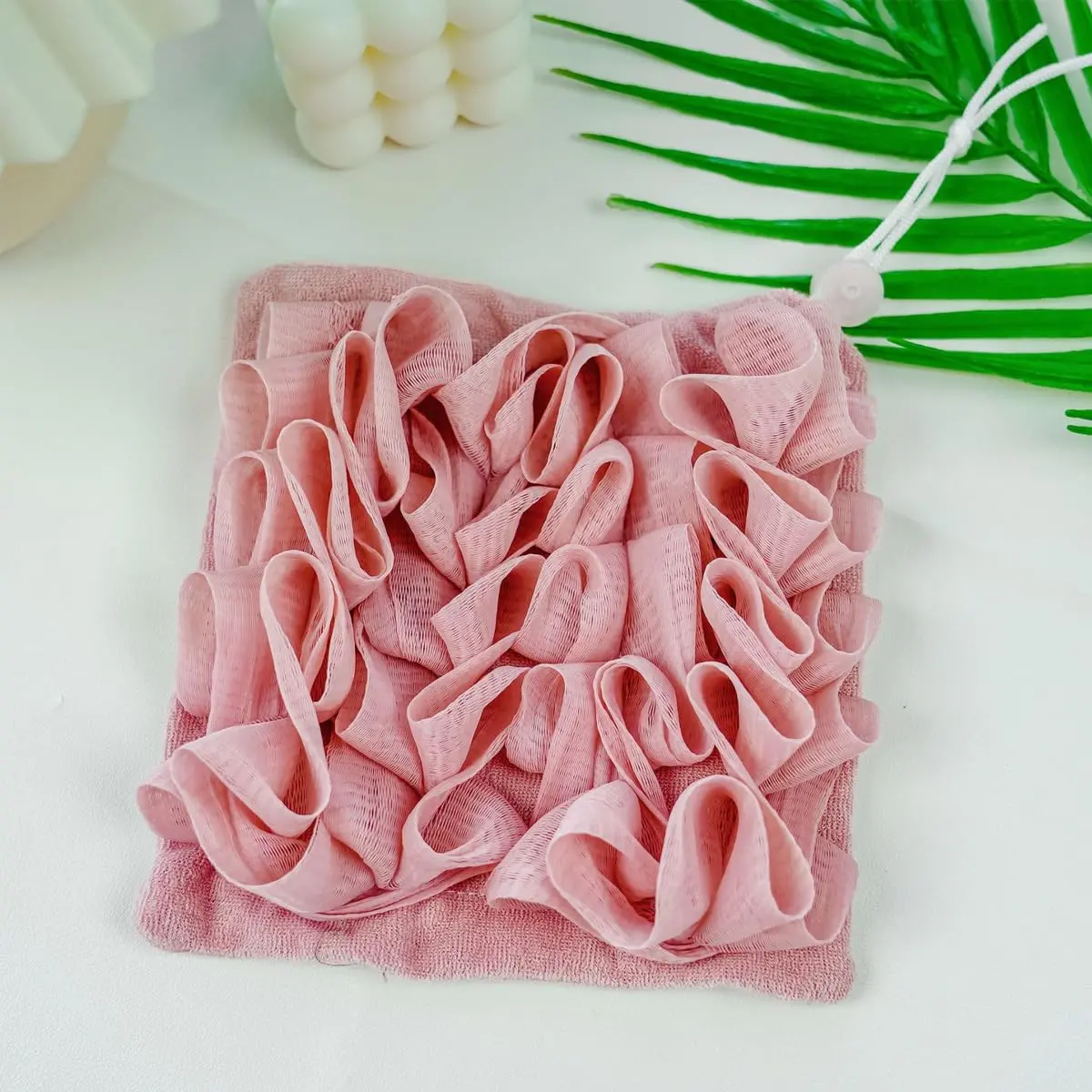 A green loofah washcloth and mesh shower ball are designed for exfoliating and cleansing with bar soap or body wash for smooth skin.