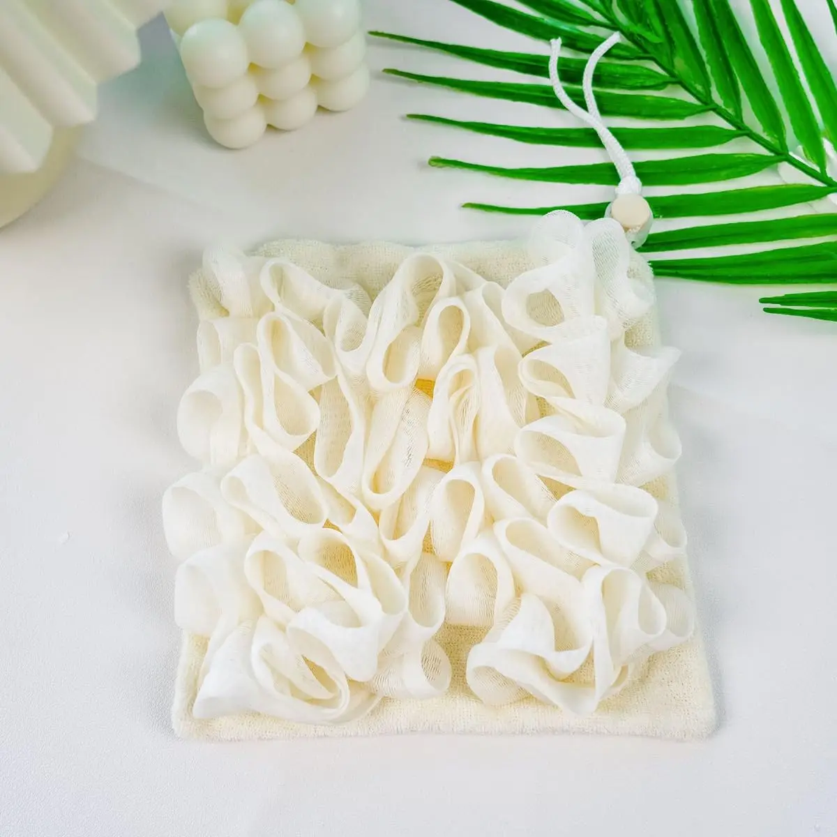 A green loofah washcloth and mesh shower ball are designed for exfoliating and cleansing with bar soap or body wash for smooth skin.