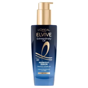 A bottle of L'Oréal Paris Elvive Extraordinary Oil Midnight Serum, a leave-in night hair oil infused with camellia oil to renourish dry hair overnight and provide frizz control for all hair types.
