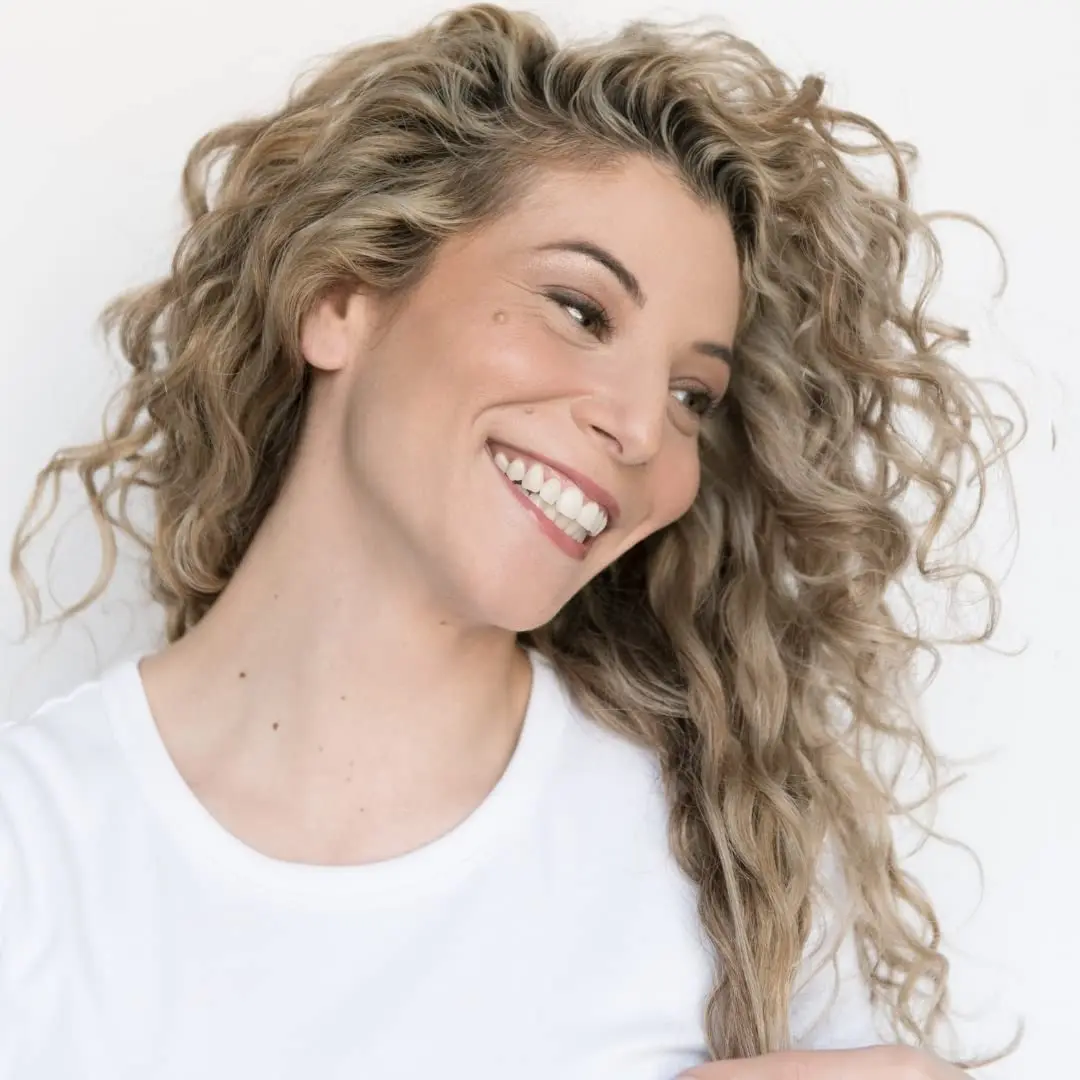 The LUS Brands All-in-One styler enhances natural wavy hair textures by providing moisture, definition, and shine without any sticky or crunchy residue.