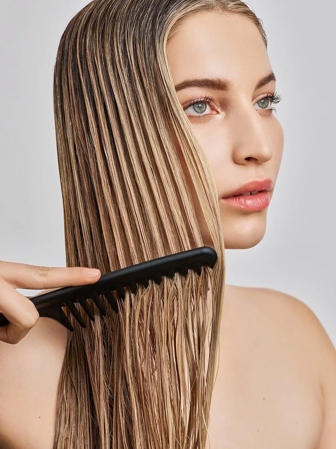 A bottle of IN COMMON Magic Myst Universal Elixir, designed to add shine, eliminate frizz and protect hair from heat styling and UV damage while sealing cuticles and repairing damage.