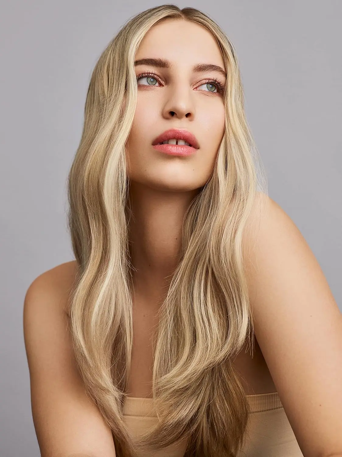 A bottle of IN COMMON Magic Myst Universal Elixir, designed to add shine, eliminate frizz and protect hair from heat styling and UV damage while sealing cuticles and repairing damage.