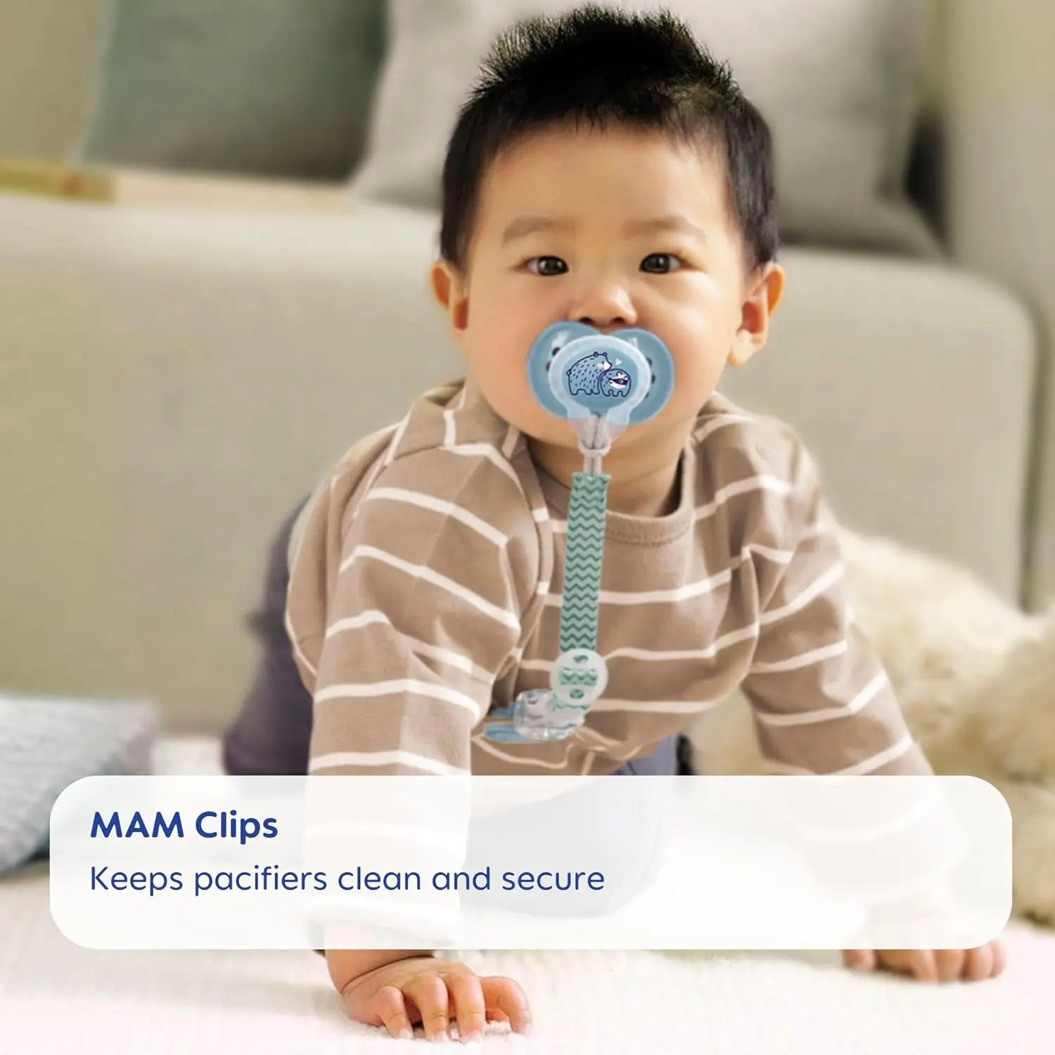 Two MAM pacifier clips with flexible rings and fasteners, designed for boys and compatible with most pacifier brands to keep them clean and secure.