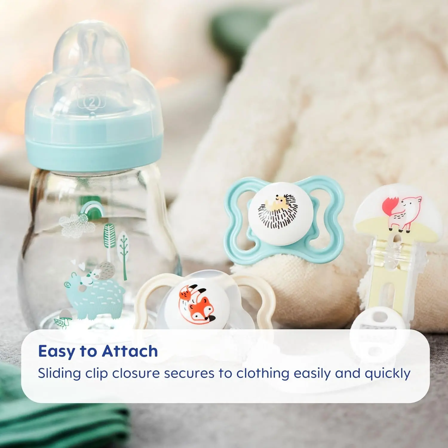 Two MAM pacifier clips with flexible rings and fasteners, designed for boys and compatible with most pacifier brands to keep them clean and secure.