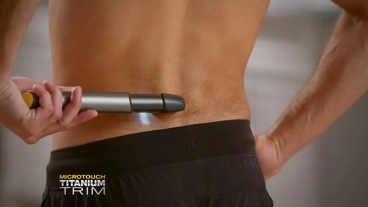 The Micro Touch Titanium Trim PRO is a rechargeable hair cutting tool and body groomer with an extendable arm, perfect for trimming hair, beards, and hard-to-reach areas like the back and shoulders.