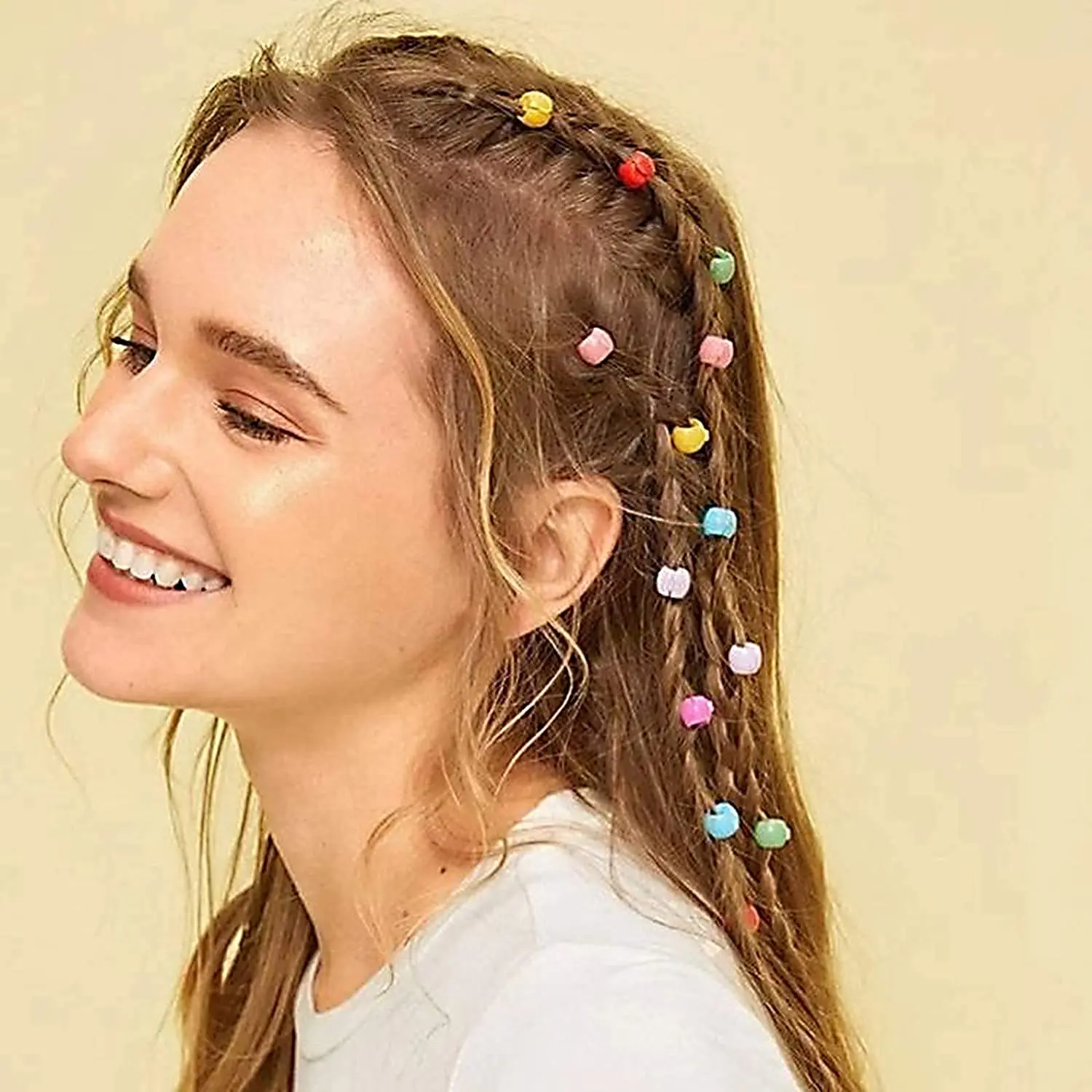 A colorful assortment of 100 mini hair claw clips, including yellow, green, red, purple, blue, and orange, ideal for creating cute and bright hairstyles for little girls, but adult supervision is needed due to small parts.