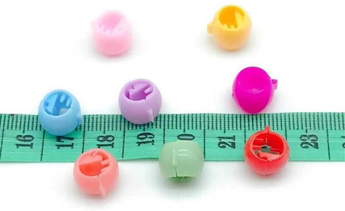 A colorful assortment of 100 mini hair claw clips, including yellow, green, red, purple, blue, and orange, ideal for creating cute and bright hairstyles for little girls, but adult supervision is needed due to small parts.