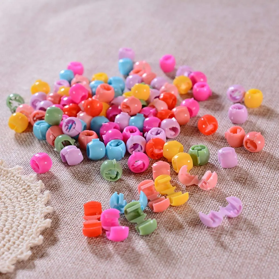 A colorful assortment of 100 mini hair claw clips, including yellow, green, red, purple, blue, and orange, ideal for creating cute and bright hairstyles for little girls, but adult supervision is needed due to small parts.