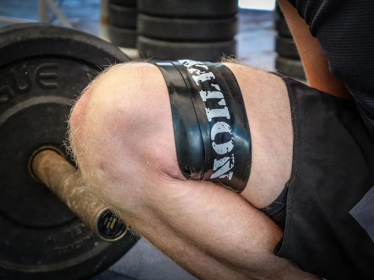 WOD Nation muscle floss bands in black and red, used for muscle recovery and improved mobility, come with a carrying case.
