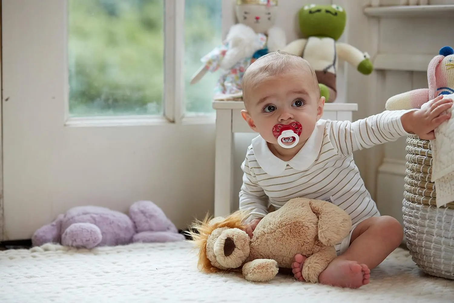 Two NUK Disney Mickey Mouse orthodontic pacifiers for babies ages 6 to 18 months, featuring an asymmetrical shape, heart-shaped shield, and reusable storage case.