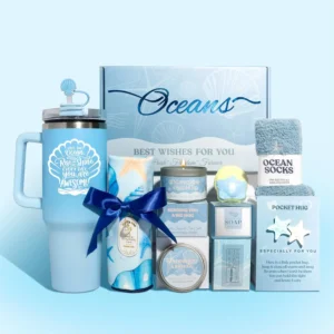 This ocean-themed gift basket includes a tumbler, candle, bath bomb, socks and card, perfect for women's birthdays and relaxation.