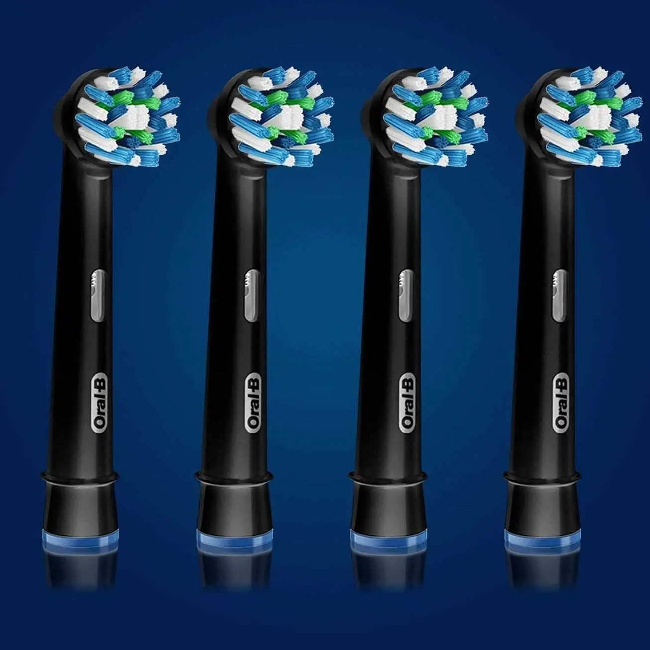 Four black Oral-B CrossAction replacement brush heads, designed with 16-degree angled bristles to remove plaque and whiten teeth, compatible with most Oral-B electric toothbrushes.