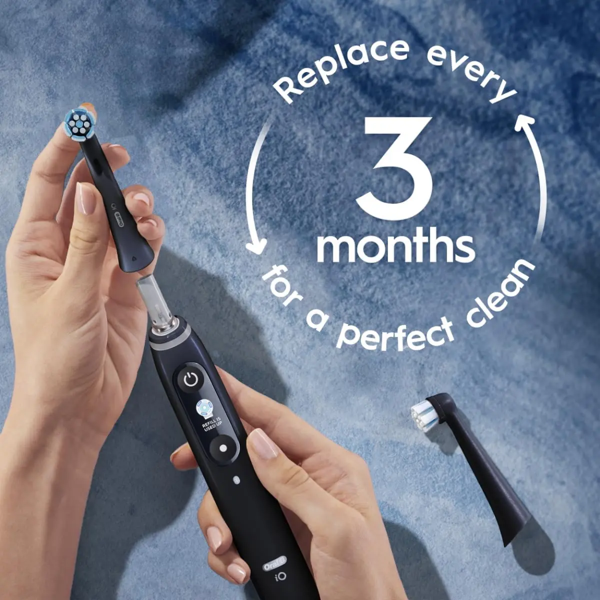 Two Oral-B iO Ultimate Clean black replacement brush heads designed for Oral-B iO electric toothbrushes, featuring round brush head and dense bristles for plaque removal.