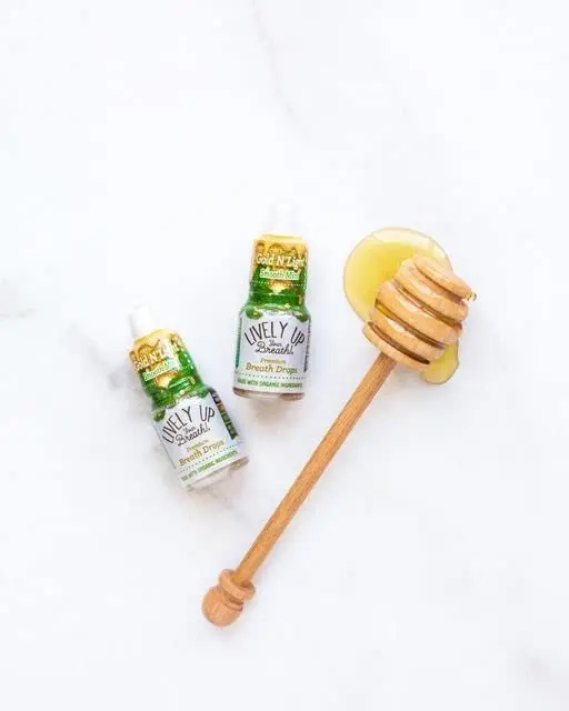 Three bottles of Lively Up Gold N' Light organic honey breath freshener offer a milder, refreshing taste with exotic ingredients for long-lasting fresh breath.