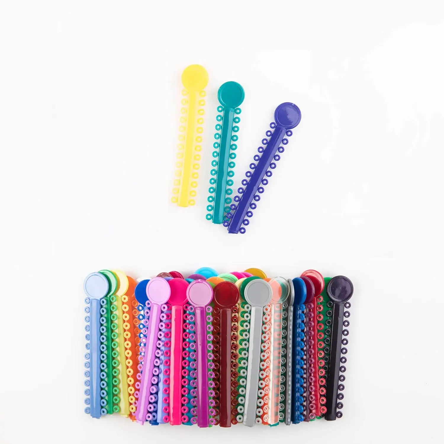 A colorful assortment of OSGP orthodontic ligature ties, also known as o-rings or braces rubber bands, used in dental braces to hold the archwire in place and available in 40 different colors.