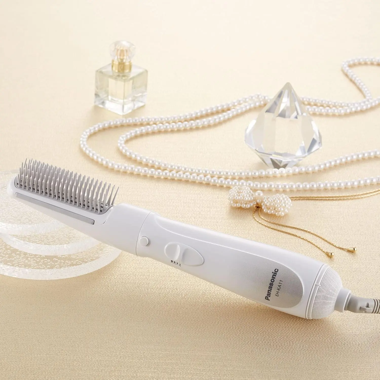 The Panasonic hair styler blow brush features a slim design and rubber sides to catch hair for effective styling with quiet operation.