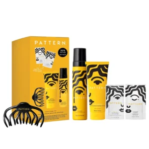 PATTERN Beauty Juicy Curl Kit with curl foam, leave-in conditioner, hair clip, shampoo and heavy conditioner packets for defining and styling natural curls.