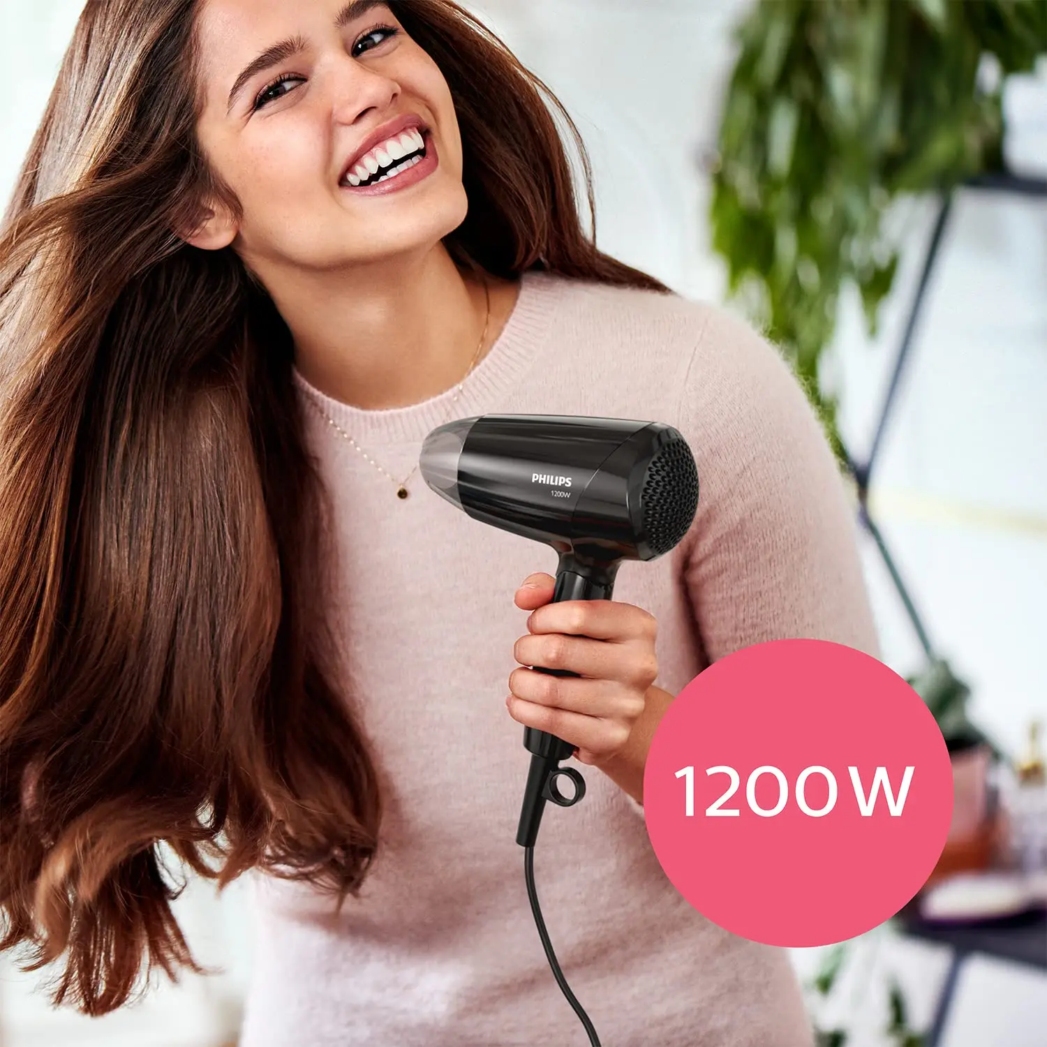 Black Philips Essential Care BHC010/10 hair dryer with ThermoProtect setting and foldable handle, offering 1200W power for quick, gentle, and shiny hair drying with three preset levels and a styling nozzle.