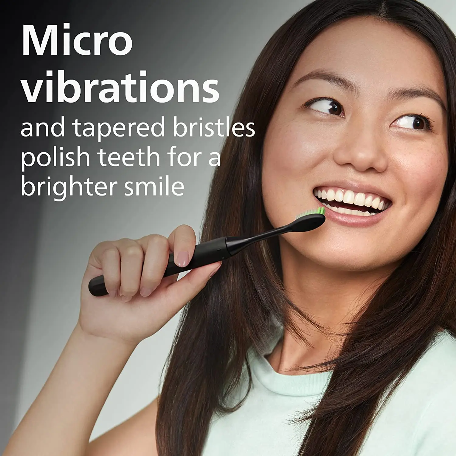 Two shadow black Philips One by Sonicare replacement brush heads with soft, tapered nylon bristles for gentle polishing and a brighter smile.
