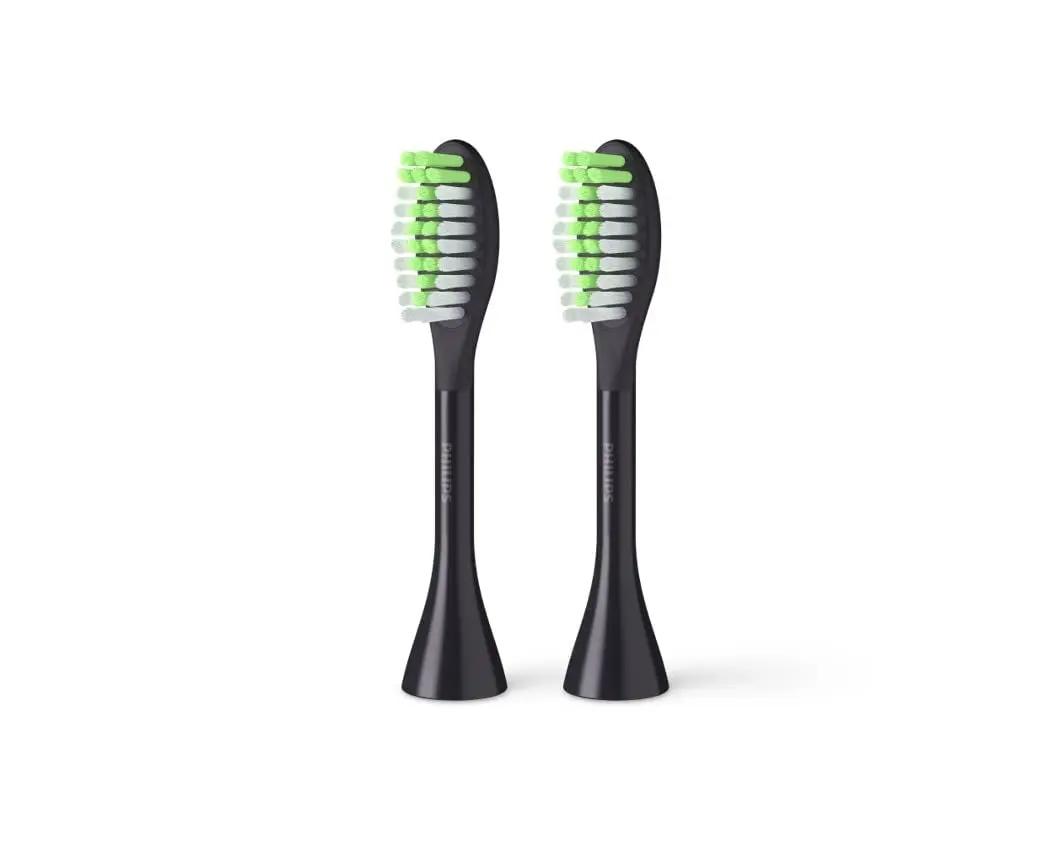 Two shadow black Philips One by Sonicare replacement brush heads with soft, tapered nylon bristles for gentle polishing and a brighter smile.