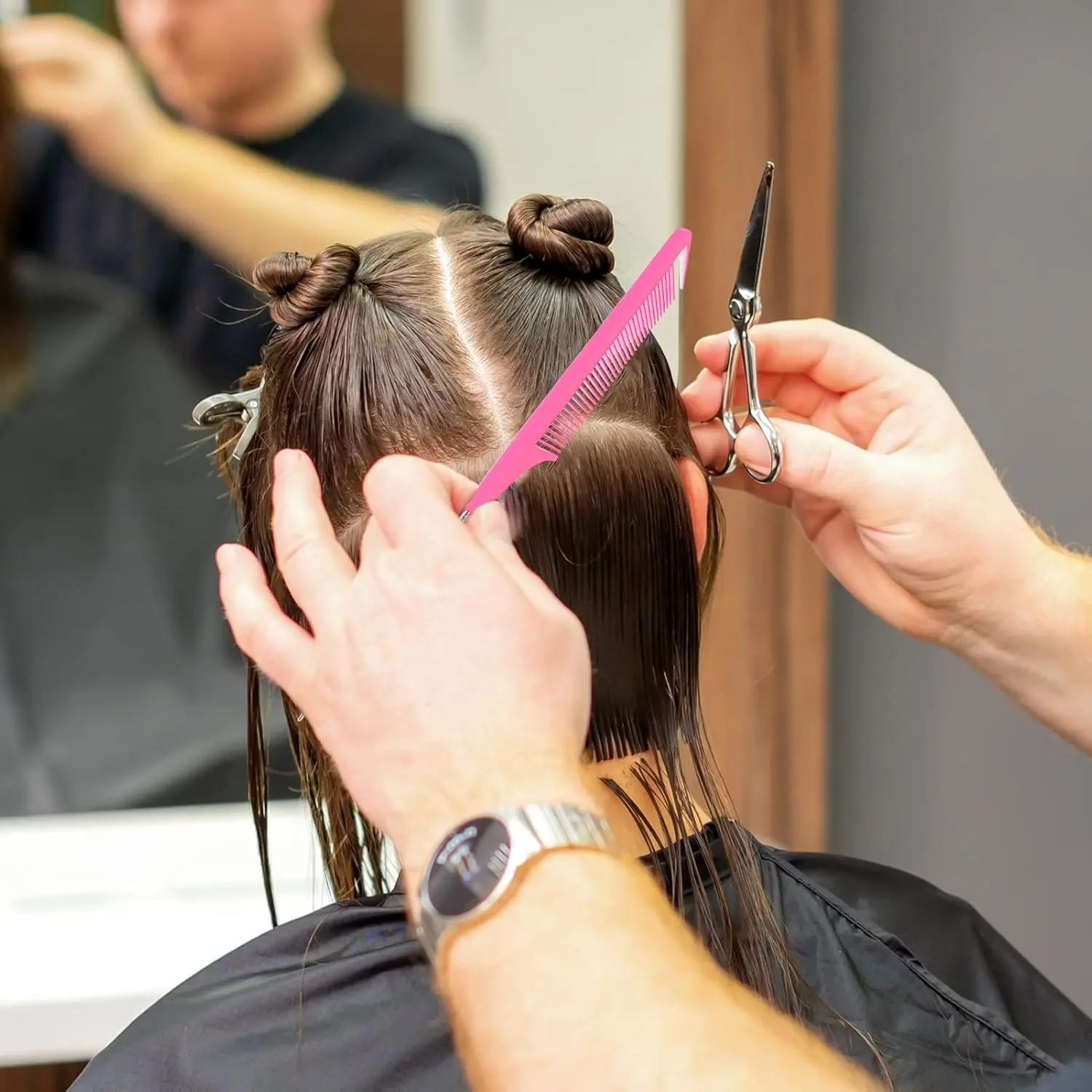 A pink rat tail comb with a stainless steel pintail is displayed, highlighting its fine teeth and design ideal for sectioning, parting, and styling hair.