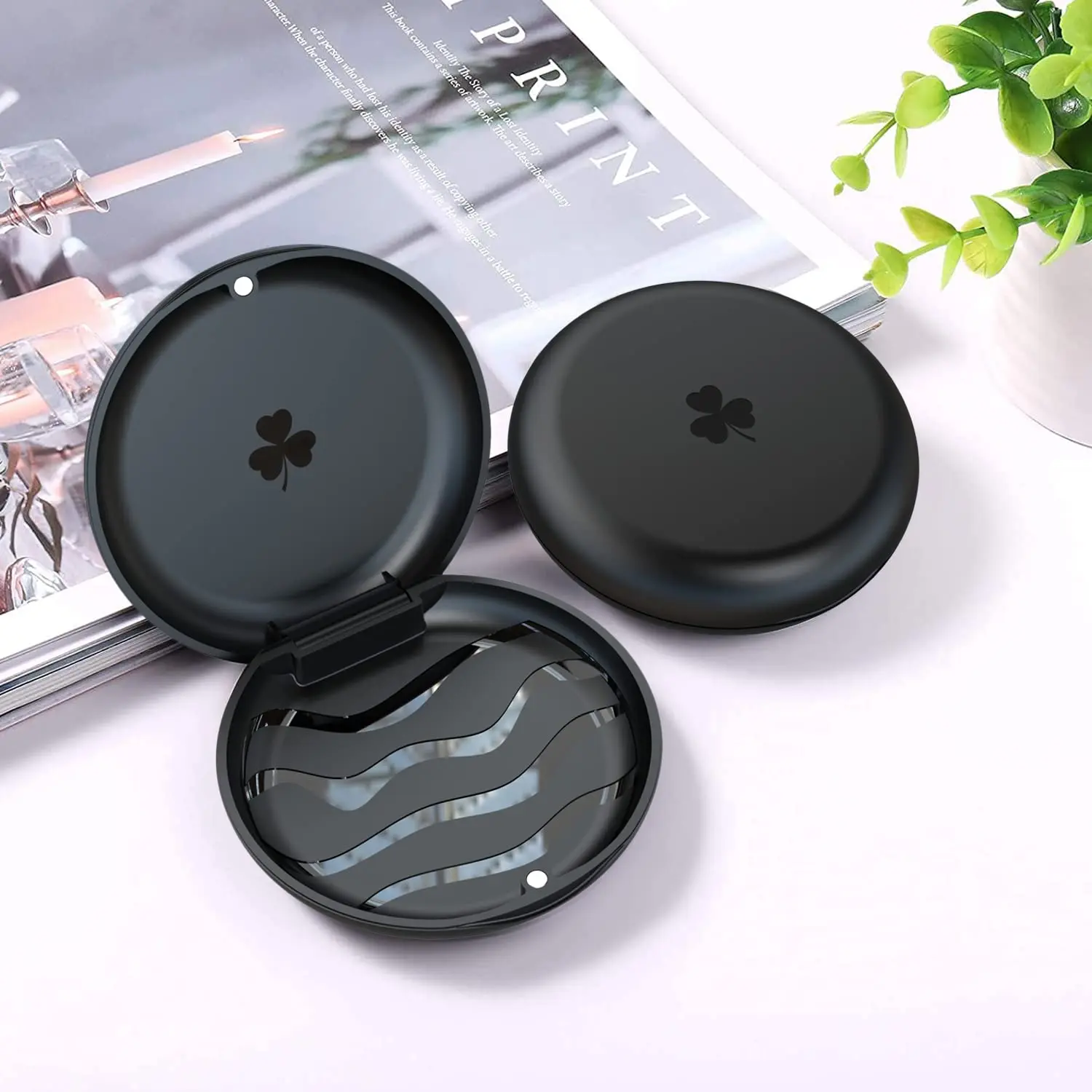 Black retainer case securely stores dental retainers, aligners, or mouthguards, protecting them from damage and contamination while traveling.
