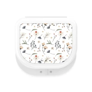 This white retainer case features a cute floral design, offering a durable and elegant way to store your mouthguard or night guard at home or while traveling.